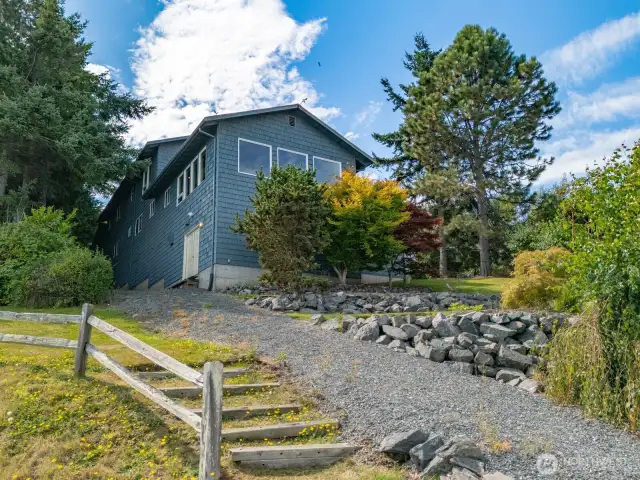Looking at the waterside of the home which is all shingles and has been freshly painted.
