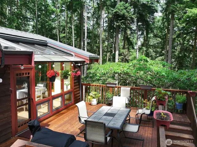 Mature landscaping surrounds you and creates a lovely buffer of privacy. Stairs to the right side of this photo lead to your spacious yard and to the lower level entrance of your home.