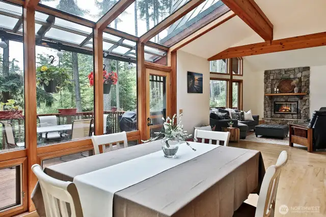 View from the dining area looking into the living room. That's a wood fireplace straight ahead. Your feet will love the solid wood floors.