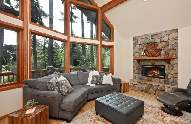 There is no lack of light in this home with the wall of windows and soaring ceiling. The substantial stone fireplace provides a central hearth to your home, a lovely place to gather with others or retreat with your avorite book.