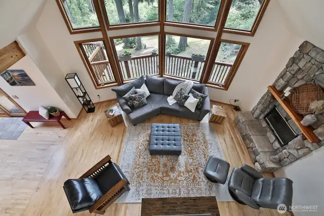 We are now on the upper level (Primary Suite #1) looking upon the open living room. Look outside and you get a sense of the generous yard.