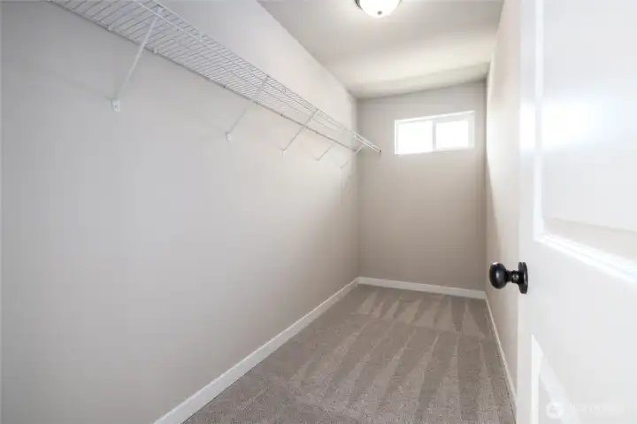 Primary bedroom walk in closet