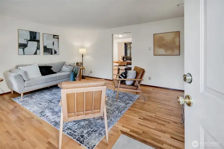 The home opens to a beautiful, naturally lit living room with hardwood flooring.