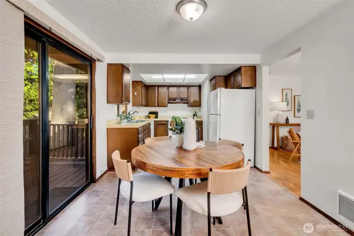 A look back at the eating area, kitchen, living room and sliders to the deck.