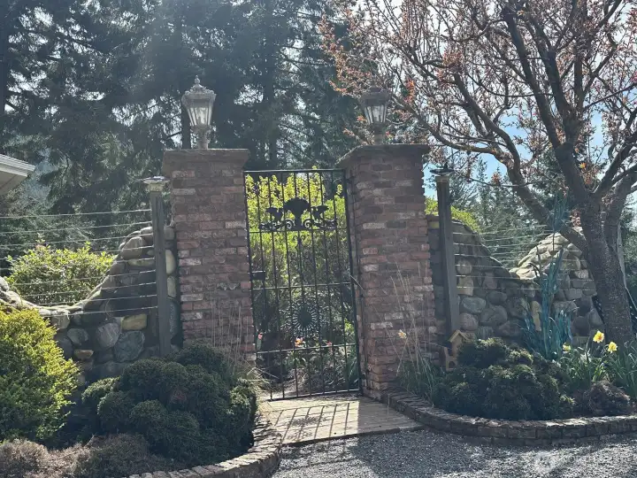 Stately brick and wrought iron gated entry