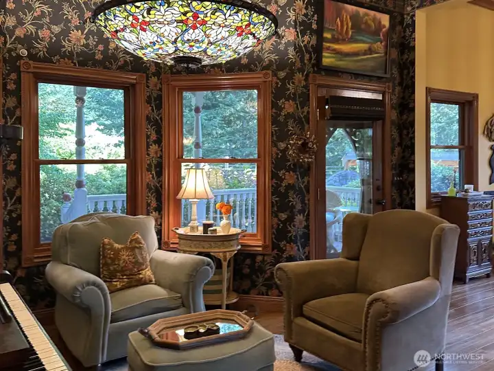 Sitting room off the kitchen and great room overlooking the covered patio and gardens