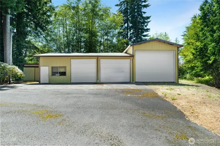 Huge 3-Bay shop with tall RV door, 2 Bays have cement floors, there's also an Office, 1/2 Bathroom, and Loft for extra storage.