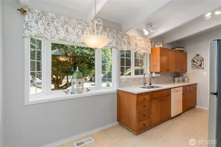 The natural light streams into this beautiful kitchen, with room for table.