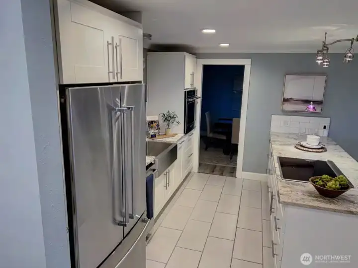 Kitchen with dining room in background.
