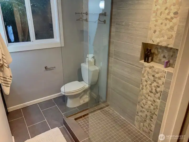 Lower level bathroom with large walk-in shower. Lower level bathroom with large walk-in shower.