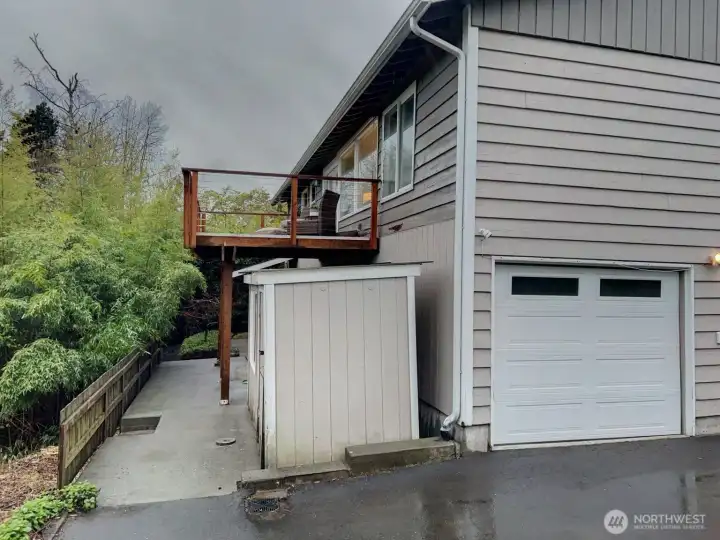 Rear of house has large deck on main level and sauna on lower level.