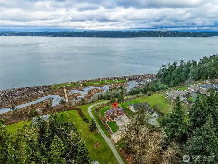 True waterfront- Property runs down the slope on a community maintained road to home's private beach / tidelands. Ability to launch kayak/smaller boats, mooring buoy option.