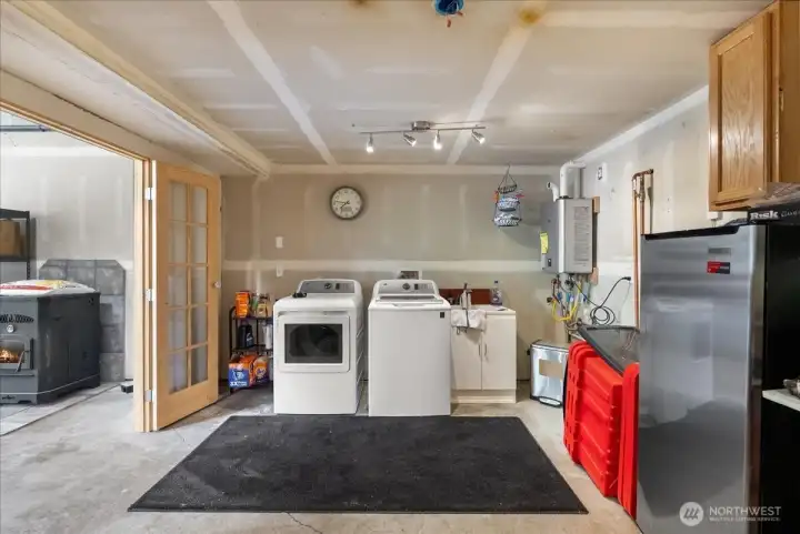 Work shop and laundry room with sink.