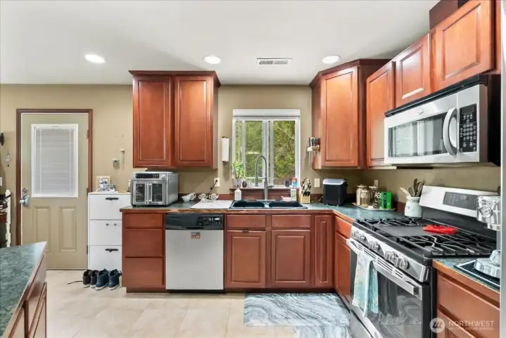 Open kitchen with stainless steel appliances.