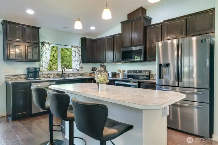 Spacious kitchen featuring a generously sized island, stainless steel appliances, and an open layout perfect for gathering and entertaining