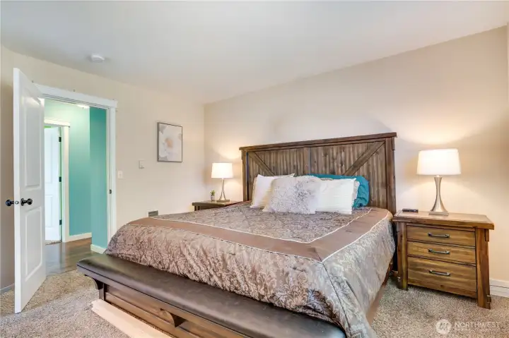Retreat down the hallway to the generous primary suite offering comfort, privacy, and plenty of space to unwind