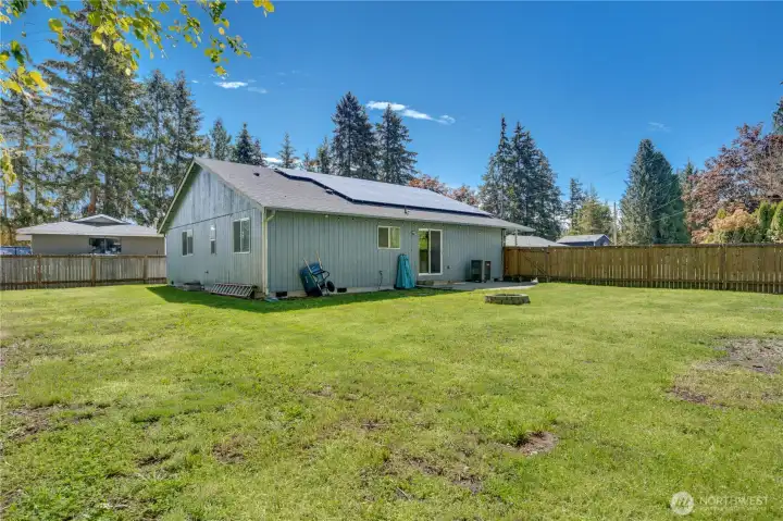 Step outside to the spacious backyard complete with a fire pit, garden space, and plenty of room for entertaining, relaxing, and enjoying the outdoors