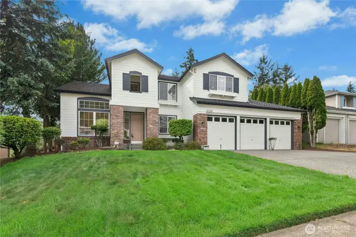 Stunning curb appeal with fresh exterior paint & mature landscaping