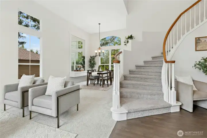 Elegant formal living room with dramatic vaulted ceilings