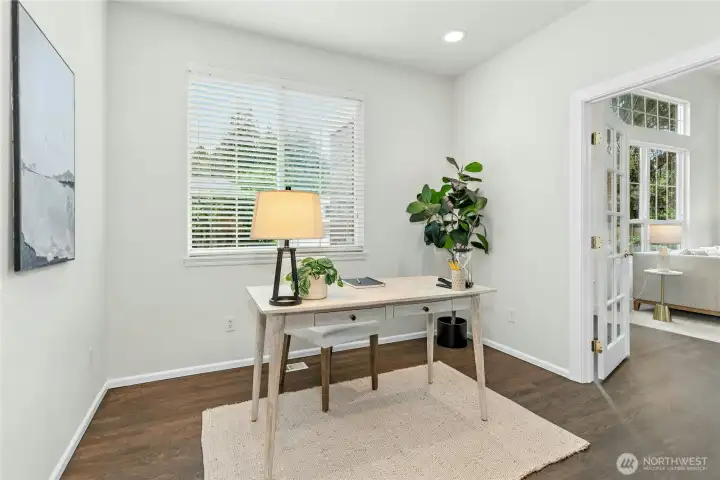 Main floor den with built-in cabinetry perfect for working from home