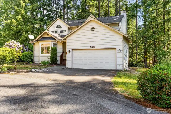 2 car garage with a man door to the back