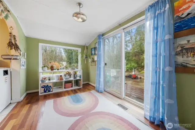 The large window and the sliding glass door provide this room with an abundance of natural light making this room light and bright.