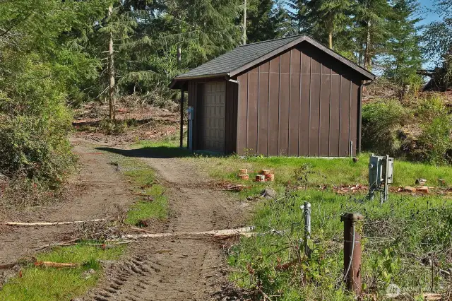 Located near the bottom of the lot, on the adjacent lot is the community well house and the properties well head.