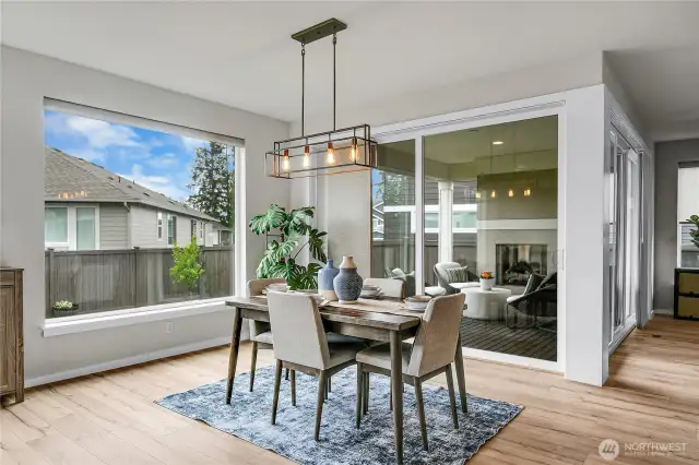 The kitchen opens onto the family and dining areas, creating that sought-after great room concept floorplan. Automated window coverings in the kitchen and dining area offer both privacy and light control.