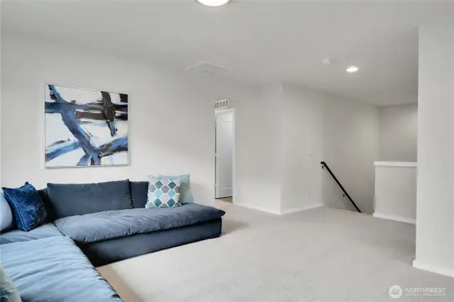 At the top of the stairs there is a leisure room with a long window letting in natural light.  This area separates the four upper level bedrooms and offers a natural meeting place in the more private part of the home.