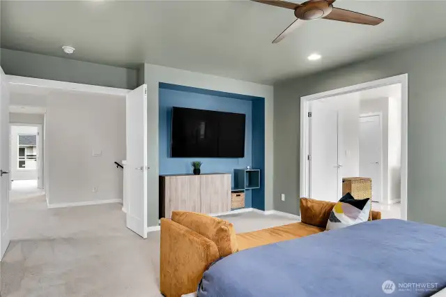 Double doors lead into the incredibly spacious, light-filled primary suite which has two oversized windows.