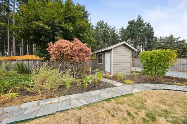 Fenced and landscaped yard with fruit tree