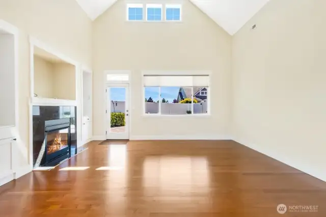 Cozy up by the gas fireplace with stunning granite surround, flanked by custom built-in cabinets that combine style, warmth, and practical storage
