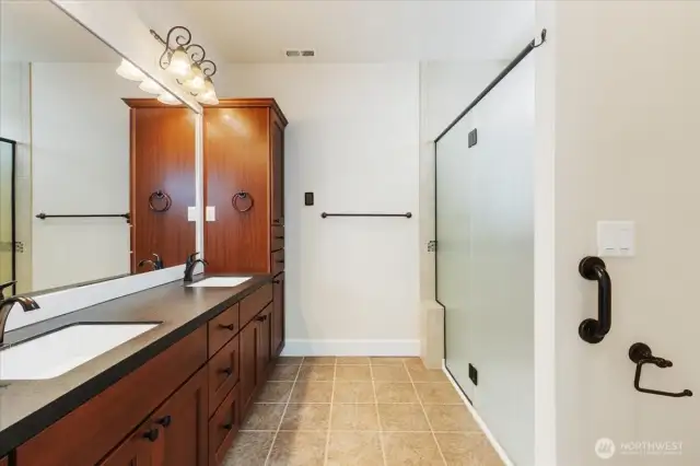Relax and unwind in the elegant primary bath featuring a beautifully tiled, spacious walk-in shower for a spa-like experience.