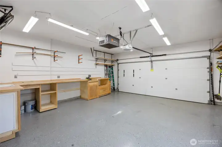 Garage has epoxy floors, heater, air filtration system, built in work benches (attic storage too!)