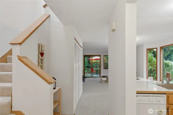 entry to stairs and kitchen with vaulted ceiling over the stairs