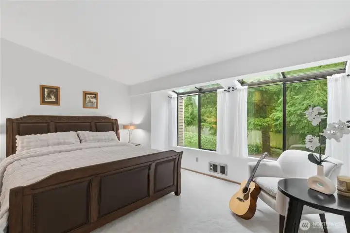 master bedroom with large windows and vaulted ceiling