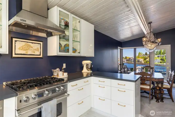 Updated kitchen with Viking gas range and glass front display cabinets.
