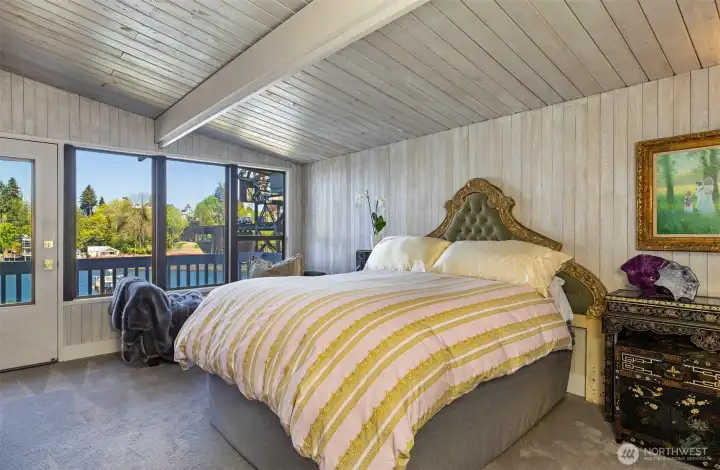 Primary bedroom suite on main floor with view balcony and full bath.