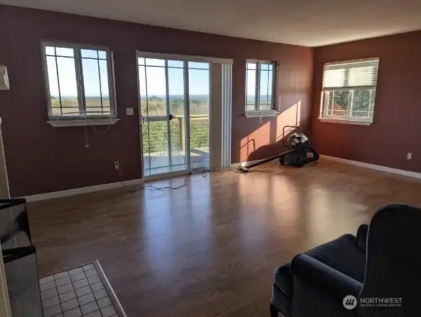 Living room on upper floor with mountain and ocean views, and access to the deck.