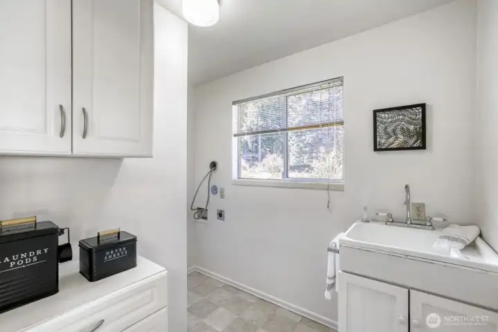 Laundry with sink and storage.