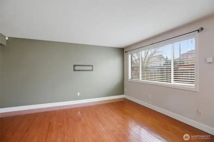 Big picture window allows for plenty of natural light and hardwoods throughout.