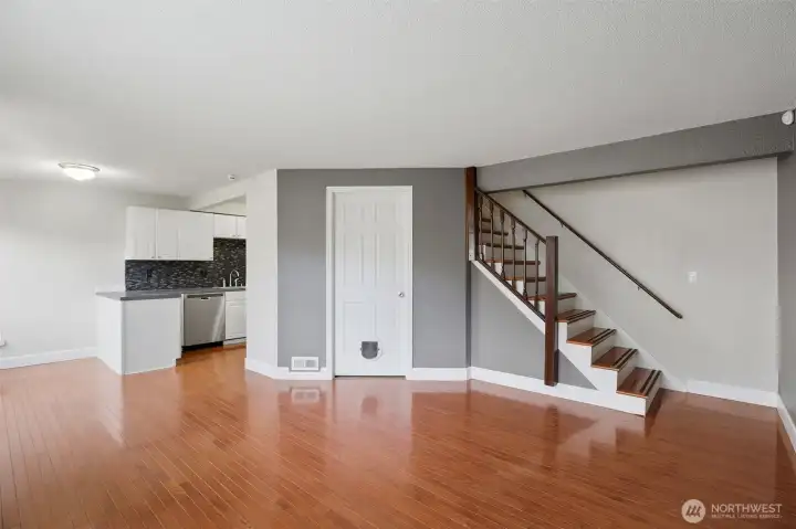 Upstairs leads to two generous bedrooms where hardwoods follow.