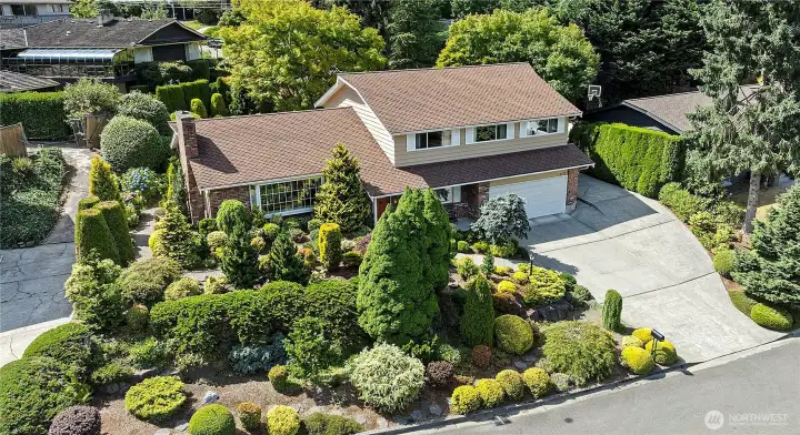 Beautiful mature landscaping, a handsome home on a quiet Lake Forest Park street
