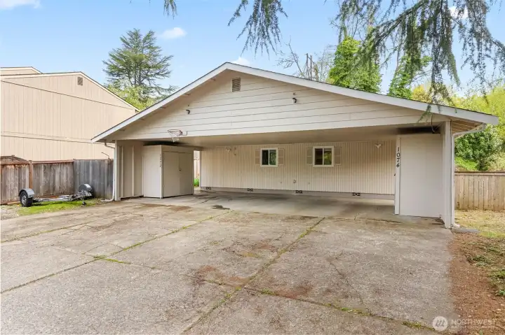 Tons of space in the parking area and a large covered carport. Storage sheds for each unit as well.