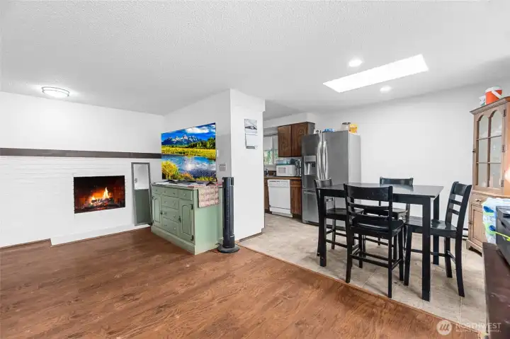 Unit 1072 living room, dining area with skylight, and kitchen.