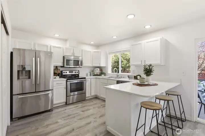 Prep meals in your updated eat-in kitchen complete with quartz countertops and stainless steel appliances.