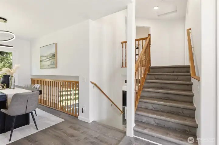 The upper stairs lead to the bedrooms and lower stairs take you to the family room.