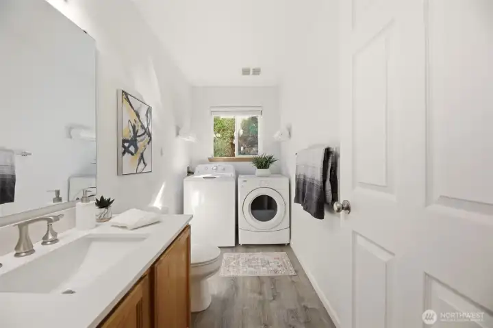 Half bath and utility room located just off the family room and garage.