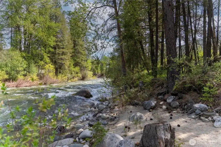 Over 500' feet of private river front with a small sandy beach to  cool off during the hot summer months.