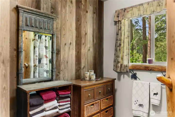 A three quarter bath includes space for linens and towels.